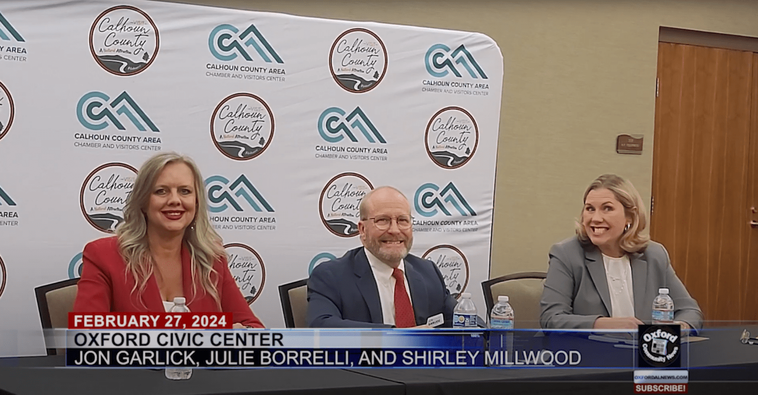 Photograph of three candidates standing behind podiums during a Probate Judge Candidates Forum in Oxford, Alabama.