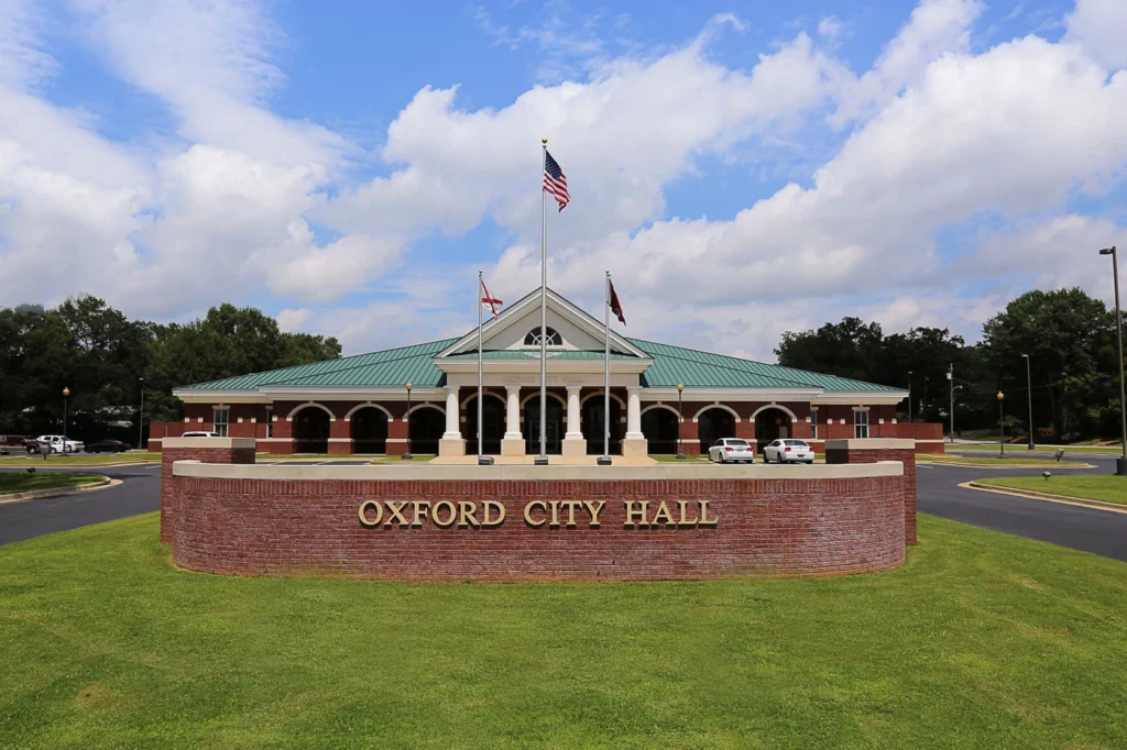 Photograph displaying the exterior view of Oxford AL City Hall, a prominent municipal building in the city.