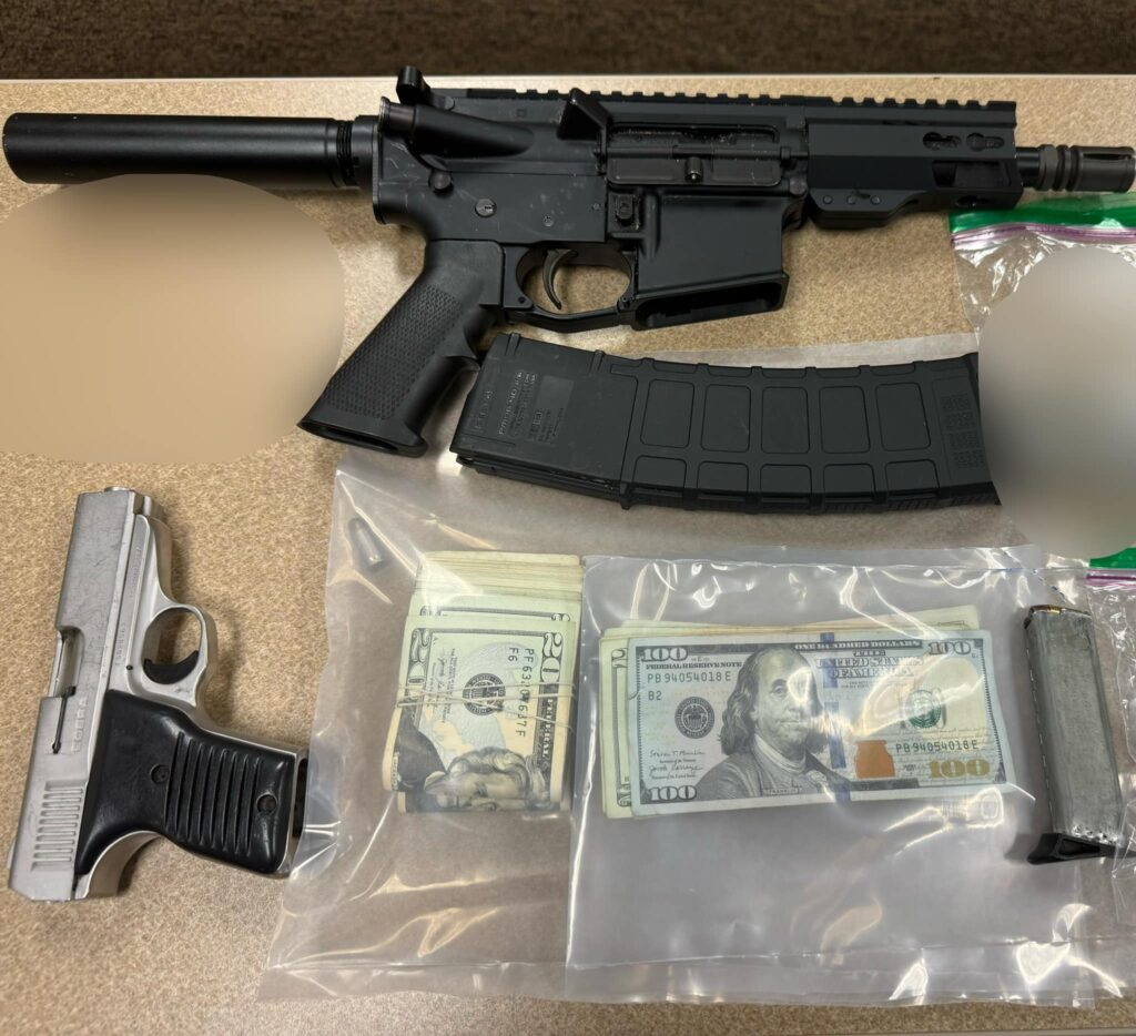 Image showing confiscated guns and stacks of money, representing evidence in a legal case.