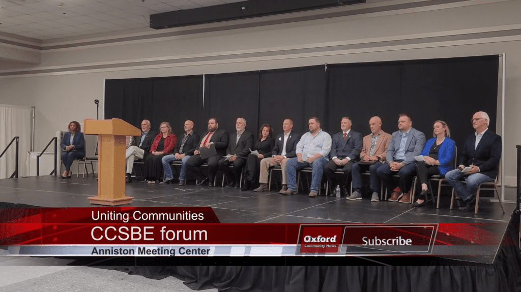 Image depicting a podium with the Calhoun County Chamber of Commerce logo and a banner indicating "School Board of Education Forum.