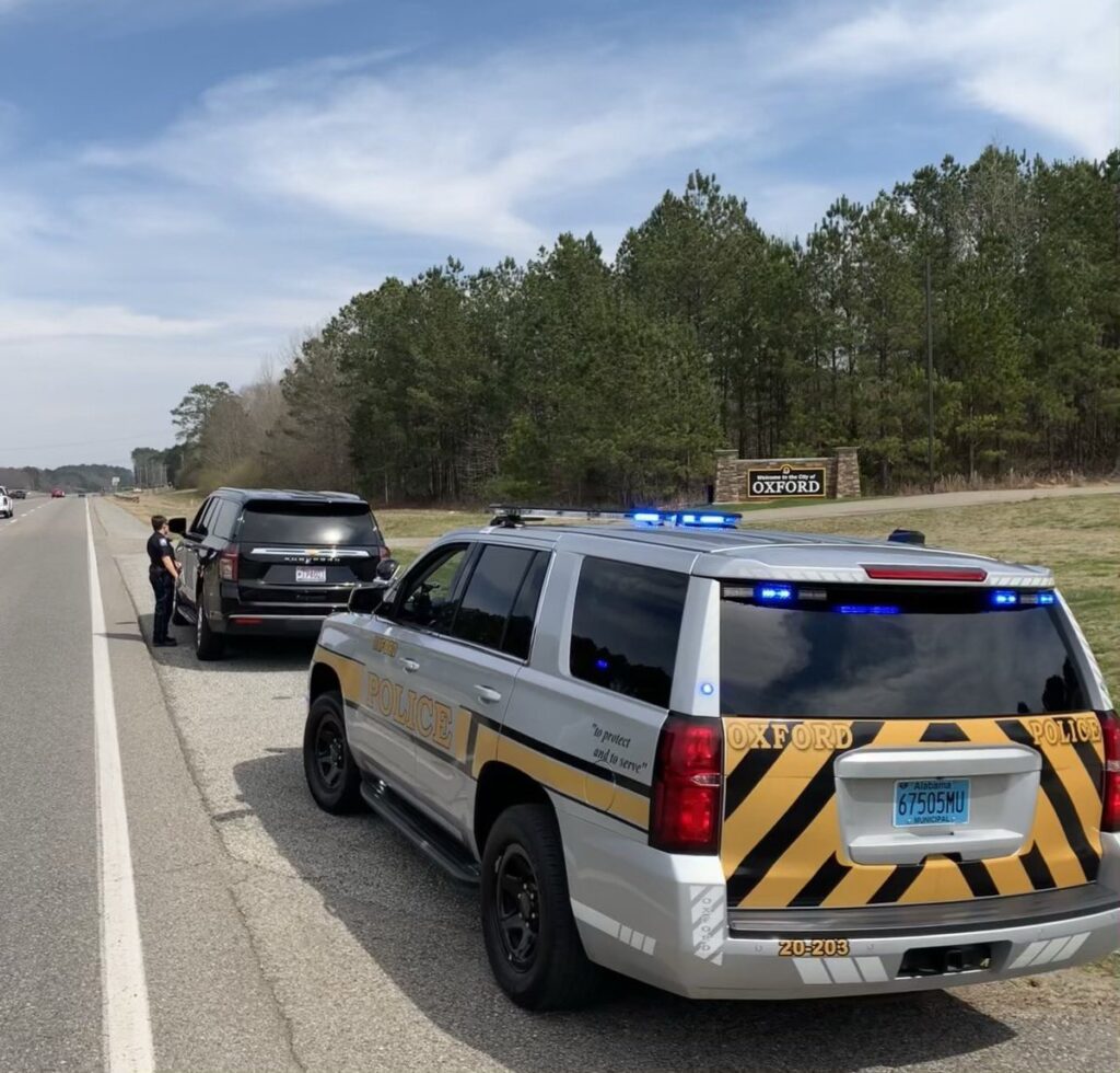 Photograph showing an Oxford Police SUV parked on the roadway.